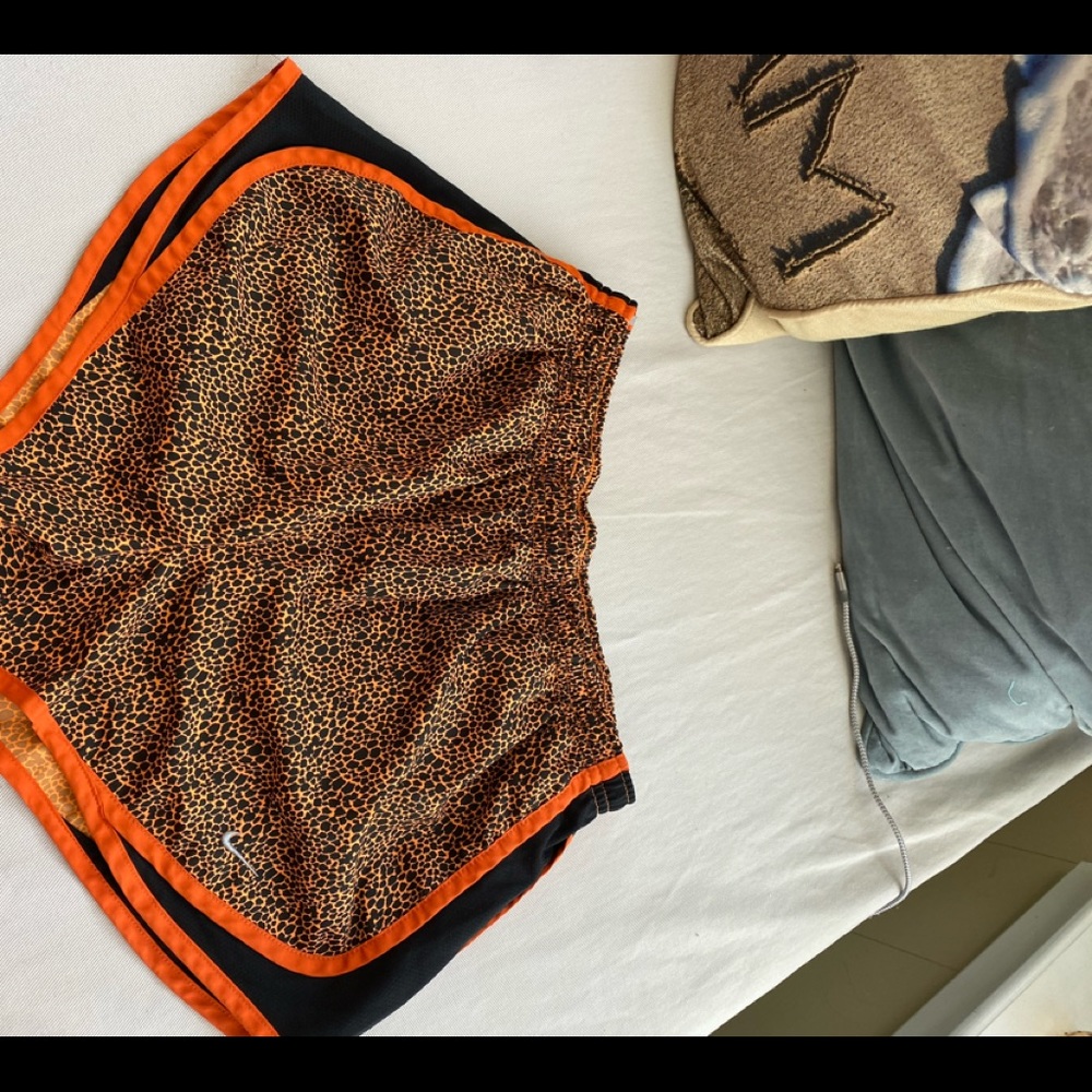 Orange and black Nike running shorts